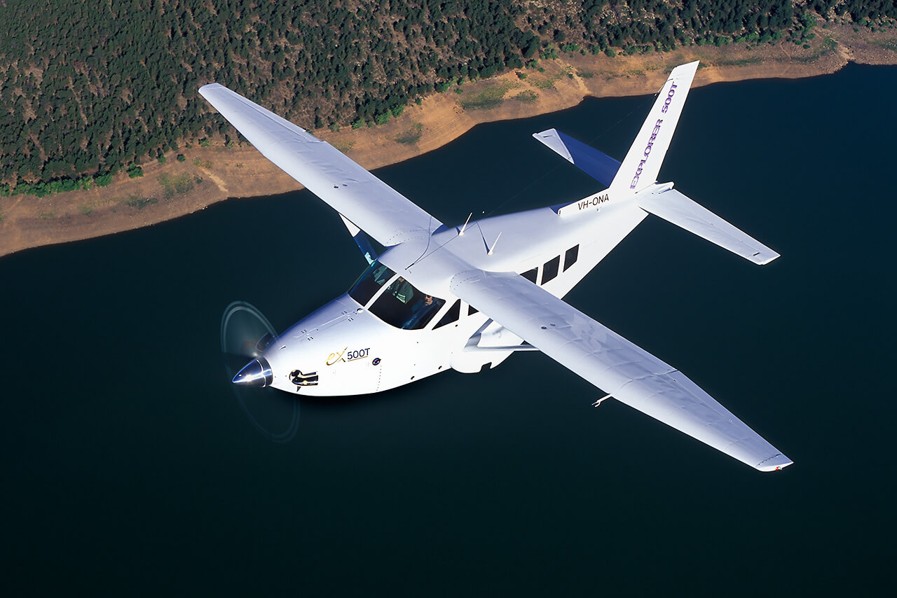 Carbon fiber utility aircraft flying over water